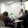 Faculty member instructing class with smart classroom projection
