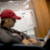 Student Looking at Laptop in Classroom Lounge Area